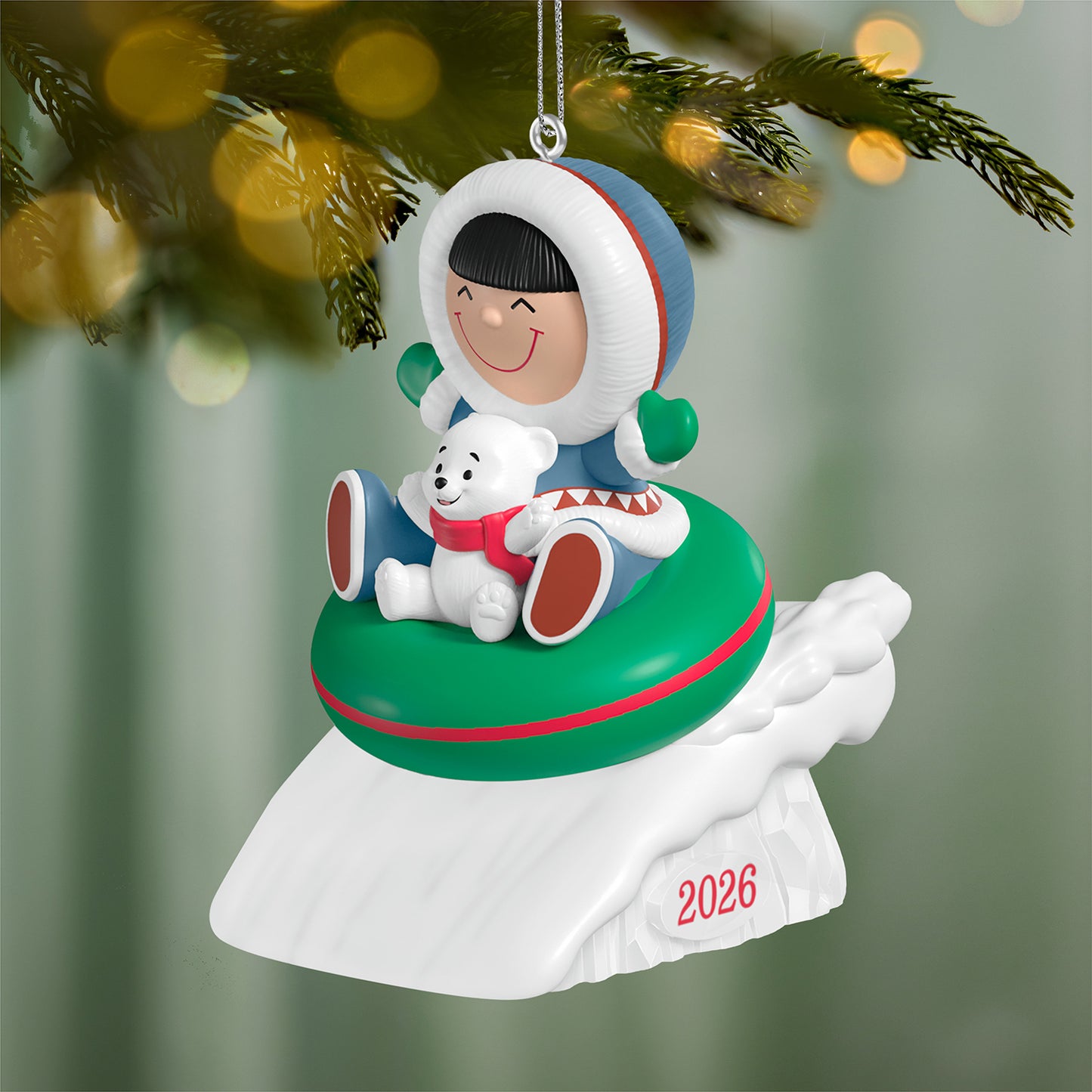 Frosty Friends 2026 — 2026 Hallmark Keepsake Christmas Ornament featuring a joyful child and polar bear on a green sled with festive detailing