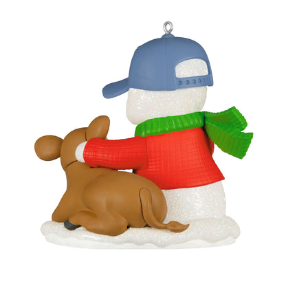 Snow Buddies, 29th in the Series — 2026 Hallmark Keepsake Christmas Ornament featuring a snowman in a red sweater and green scarf, cuddling a brown dog.