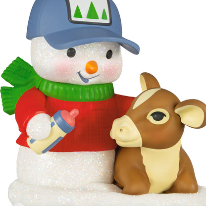 Snow Buddies, 29th in the Series — 2026 Hallmark Keepsake Christmas Ornament, featuring a glittery snowman in a red sweater and cap, feeding a calf.