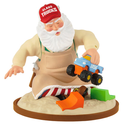 Toymaker Santa, 27th in the Series — 2026 Hallmark Keepsake Christmas Ornament featuring Santa in a workshop apron testing a toy truck in sand.