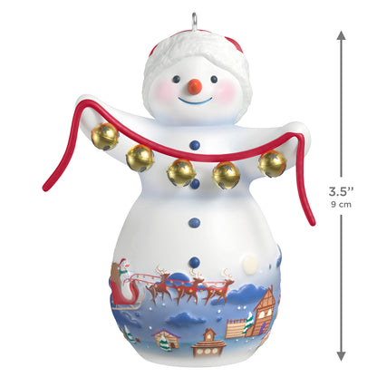 Snowtop Lodge Belle V. Holliday, porcelain, 22nd in the series — 2026 Hallmark Keepsake Christmas Ornament, featuring snowman with gold bells, front view.