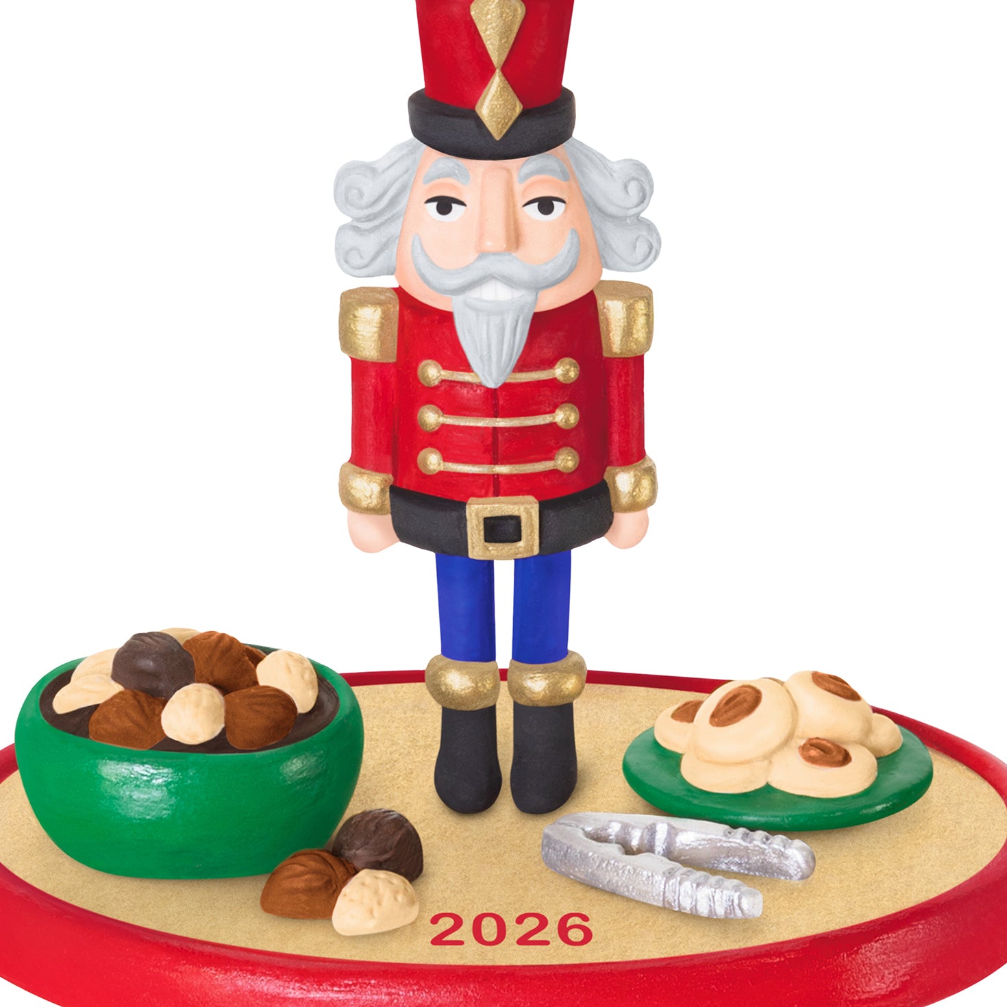 Season's Treatings 2026, 18th in the Series — 2026 Hallmark Keepsake Christmas Ornament featuring a nutcracker soldier, colourful bowls of nuts and cookies, close-up view.