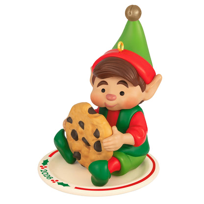 North Pole Tree Trimmers, 14th in the Series — 2026 Hallmark Keepsake Christmas Ornament featuring an elf enjoying a chocolate chip cookie on a decorative plate.