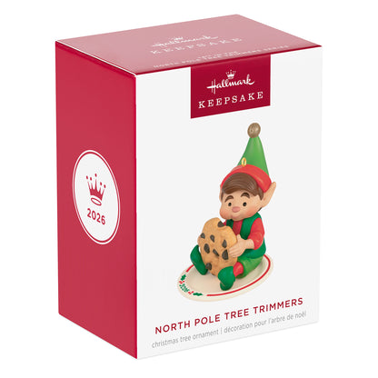 North Pole Tree Trimmers, 14th in the Series — 2026 Hallmark Keepsake Christmas Ornament in festive packaging, featuring an elf with a cookie.