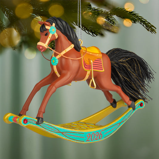 Rocking Horse Memories 2026, 7th in the Series — 2026 Hallmark Keepsake Christmas Ornament, detailed rocking horse with golden brown colour and colourful accents, hanging on tree.