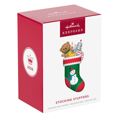 Stocking Stuffers, 6th in the Series — 2026 Hallmark Keepsake Christmas Ornament packaging box, featuring a festive design with toys and a snowman.