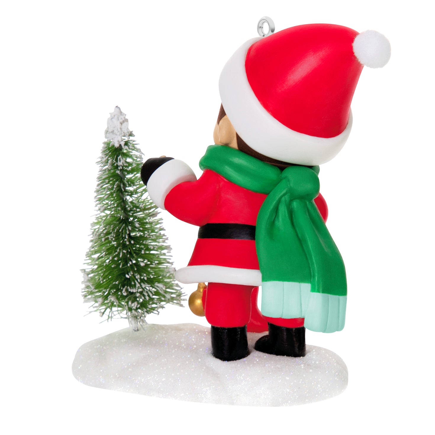 Young Santa, 5th in the Series — 2026 Hallmark Keepsake Christmas Ornament featuring a young boy in a red suit and green scarf decorating a snowy tree.