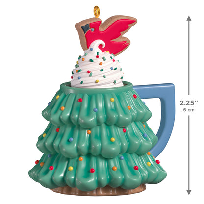 Cup of Cozy, Porcelain, 3rd in the Series — 2026 Hallmark Keepsake Christmas Ornament features a festive tree-shaped mug with whipped topping and a cardinal cookie on top, showing bright colours.