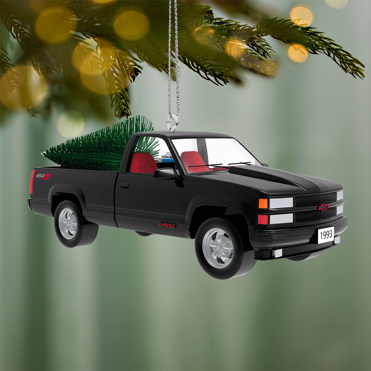 All-American Trucks 1993 Chevrolet® 454 SS 2026, metal, black with red interior and bottlebrush tree attachment, hanging on a Christmas tree.