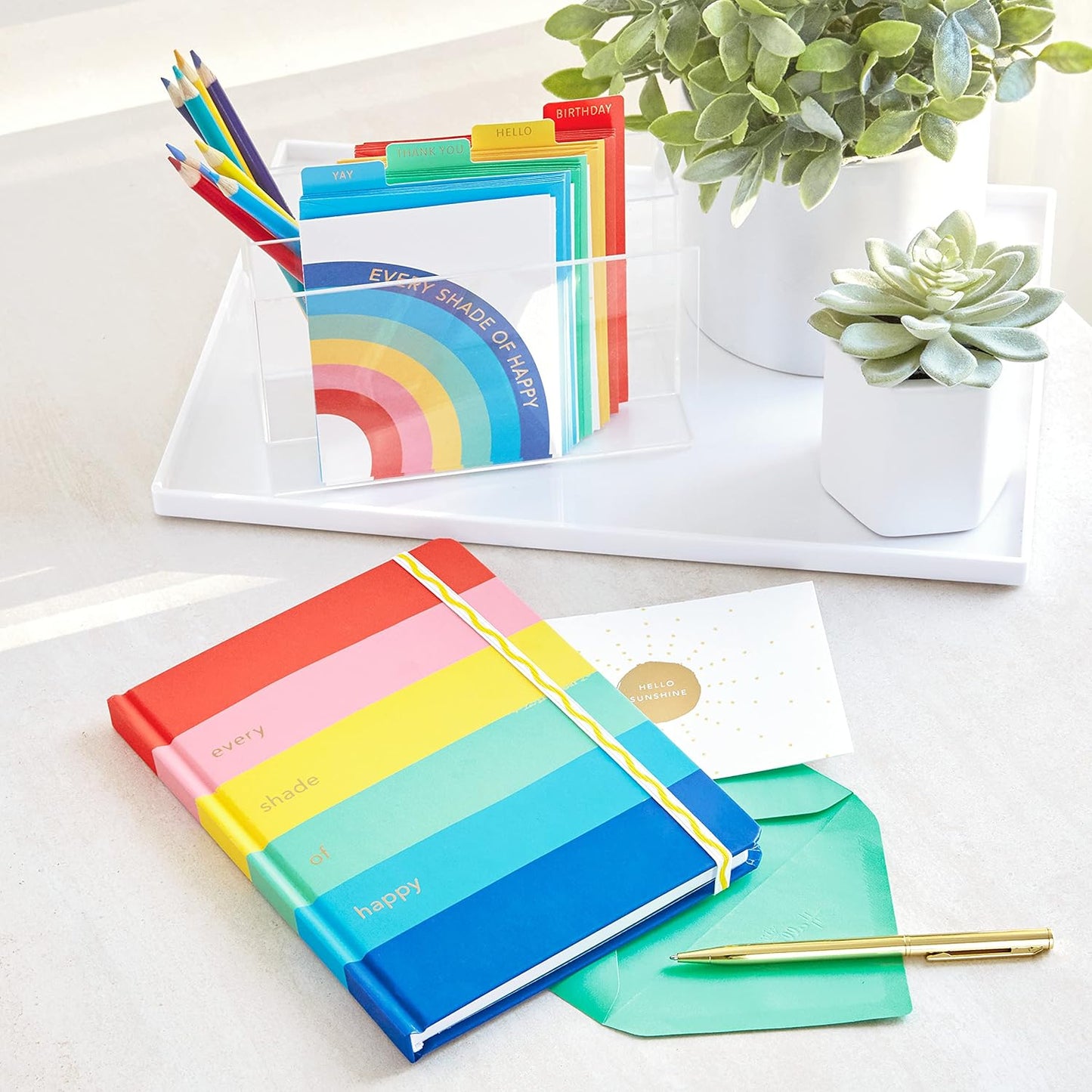 Hallmark Crayola Hardcover Journal, Rainbow (196 Pages) flat lay view showcasing colourful striped cover and desk accessories.