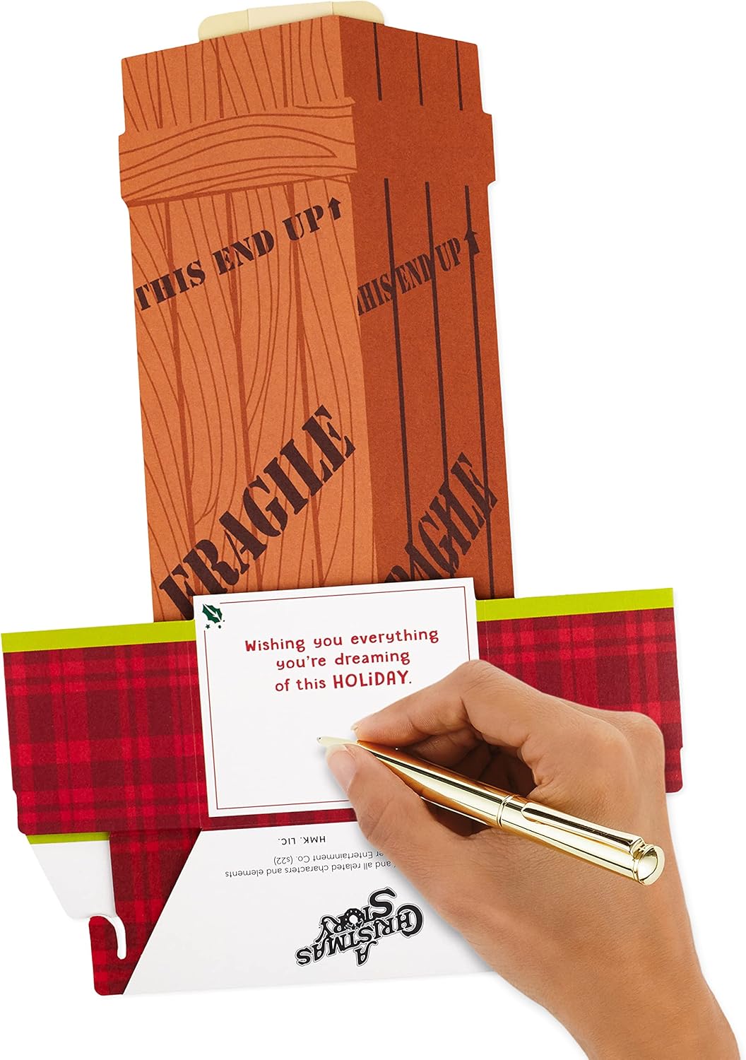 Hallmark Paper Wonder Displayable Pop Up Christmas Card (A Christmas Story Leg Lamp) being handwritten on, showcasing the themed elaborate design.