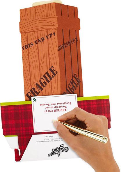 Hallmark Paper Wonder Displayable Pop Up Christmas Card (A Christmas Story Leg Lamp) being handwritten on, showcasing the themed elaborate design.