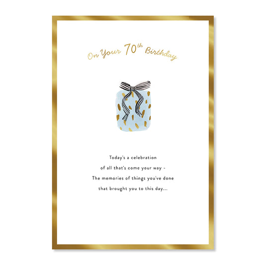 Hallmark 70th Birthday Card - Special Day features gold foil highlights, patterned gift illustration, and heartfelt message, flat lay view.