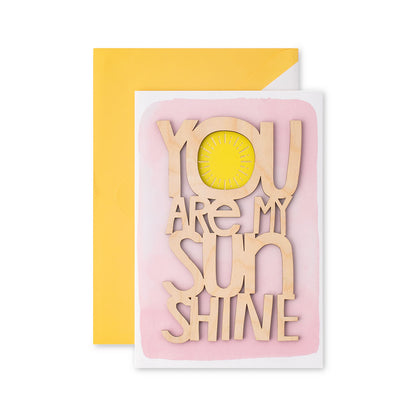 Hallmark Signature Mother's Day Card - You Are My Sunshine, featuring wooden lettering on a pink background with a yellow envelope.