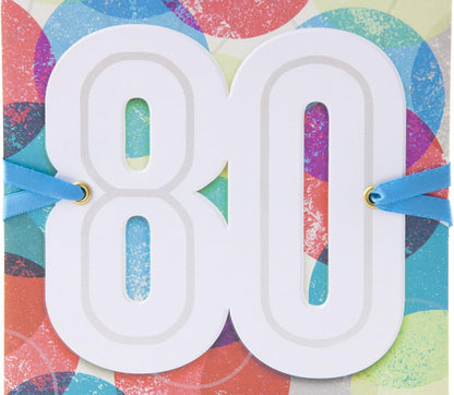 Hallmark 80th Birthday Greeting Card (Color Orbs) featuring a prominent cut-out "80" with blue ribbon accents against a colourful orb background.