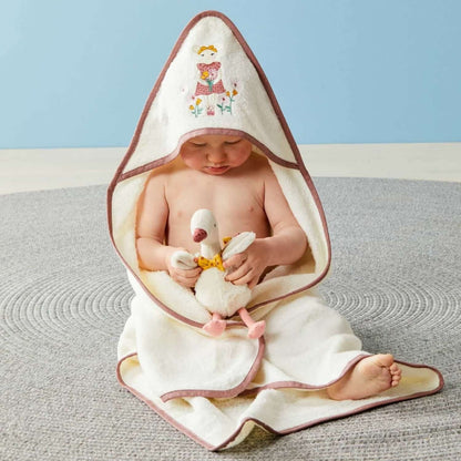 Gregory Goose rattle held by a baby wrapped in a cotton hooded towel, featuring a cute design, cosy and stylish.