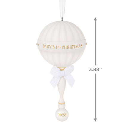 Baby's First Christmas (2023) porcelain rattle — Hallmark Keepsake Christmas Ornament with gold text and ribbon, hanging view, 9.9cm