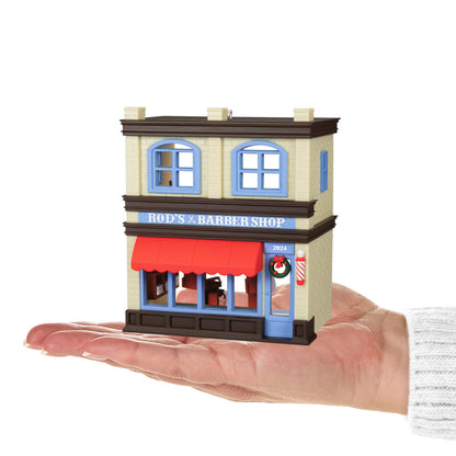 Nostalgic Houses and Shops Rod's Barbershop — Hallmark Keepsake Christmas Ornament held in hand, detailed shop front with wreath and red awning.