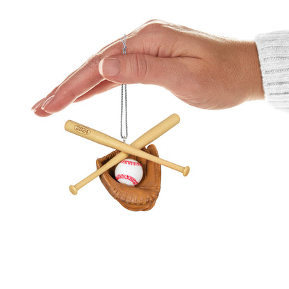 Baseball Star — Hallmark Keepsake Christmas Ornament held in hand, featuring a baseball, catcher's mitt, and crossed bats in a close-up view.