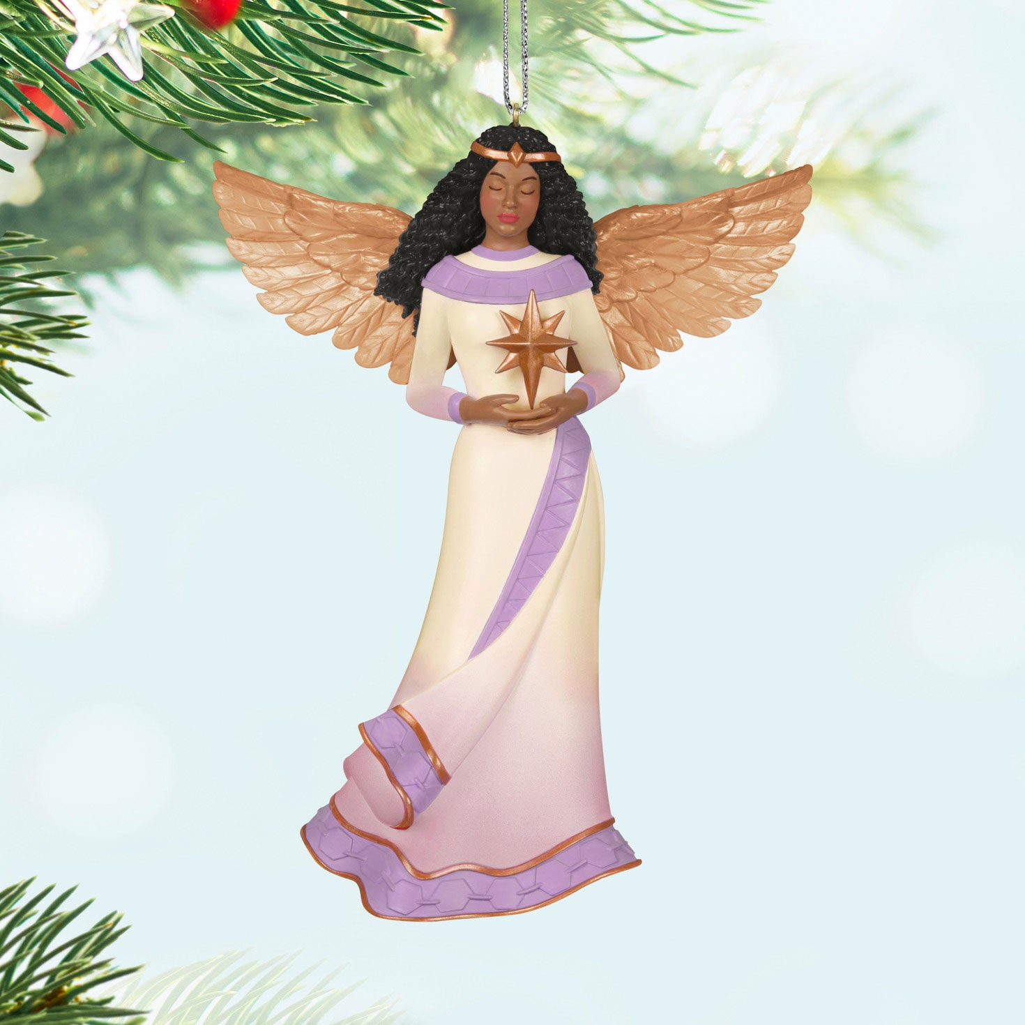 Angel of Light — Hallmark Keepsake Christmas Ornament featuring a detailed angel in a white and purple gown holding a star against a soft background.