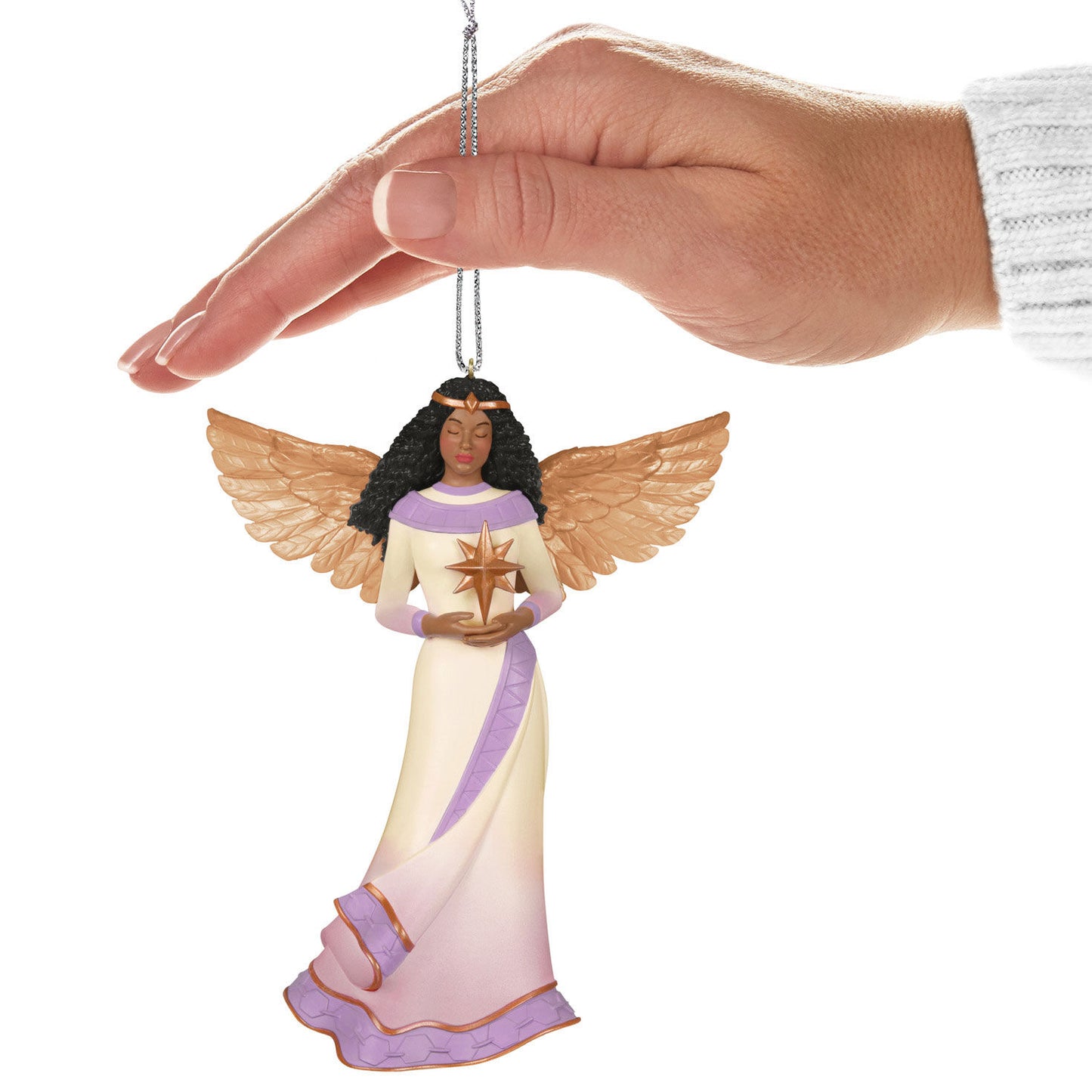 Angel of Light — Hallmark Keepsake Christmas Ornament, plastic decoration with detailed wings, held by a hand.