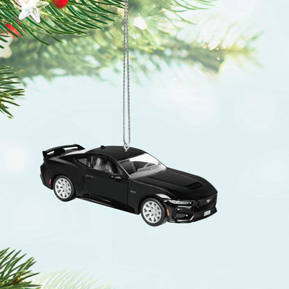 Ford Mustang GT (Metal) — Hallmark Keepsake Christmas Ornament, black metal design, displayed hanging among Christmas tree branches.