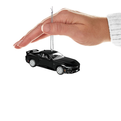 Ford Mustang GT (Metal) — Hallmark Keepsake Christmas Ornament held above a hand, showcasing its sleek black design and shiny wheels.