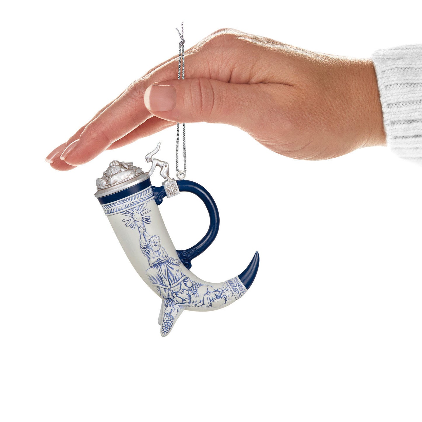Beer stein — Hallmark Keepsake Christmas Ornament held in hand, featuring a blue and white cornucopia design with an elegant lid.