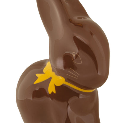 Chocolate bunny with a yellow bow on a white background
