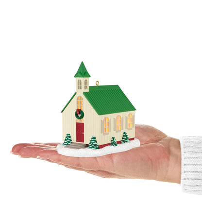 The Light of Hope — Hallmark Keepsake Christmas Ornament, small church with a green roof and red door, held in a hand.