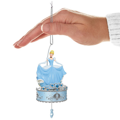 Disney Cinderella, Twirling at the Ball — Hallmark Keepsake Christmas Ornament held by a hand, featuring Cinderella in a blue gown and a pumpkin-carriage base.