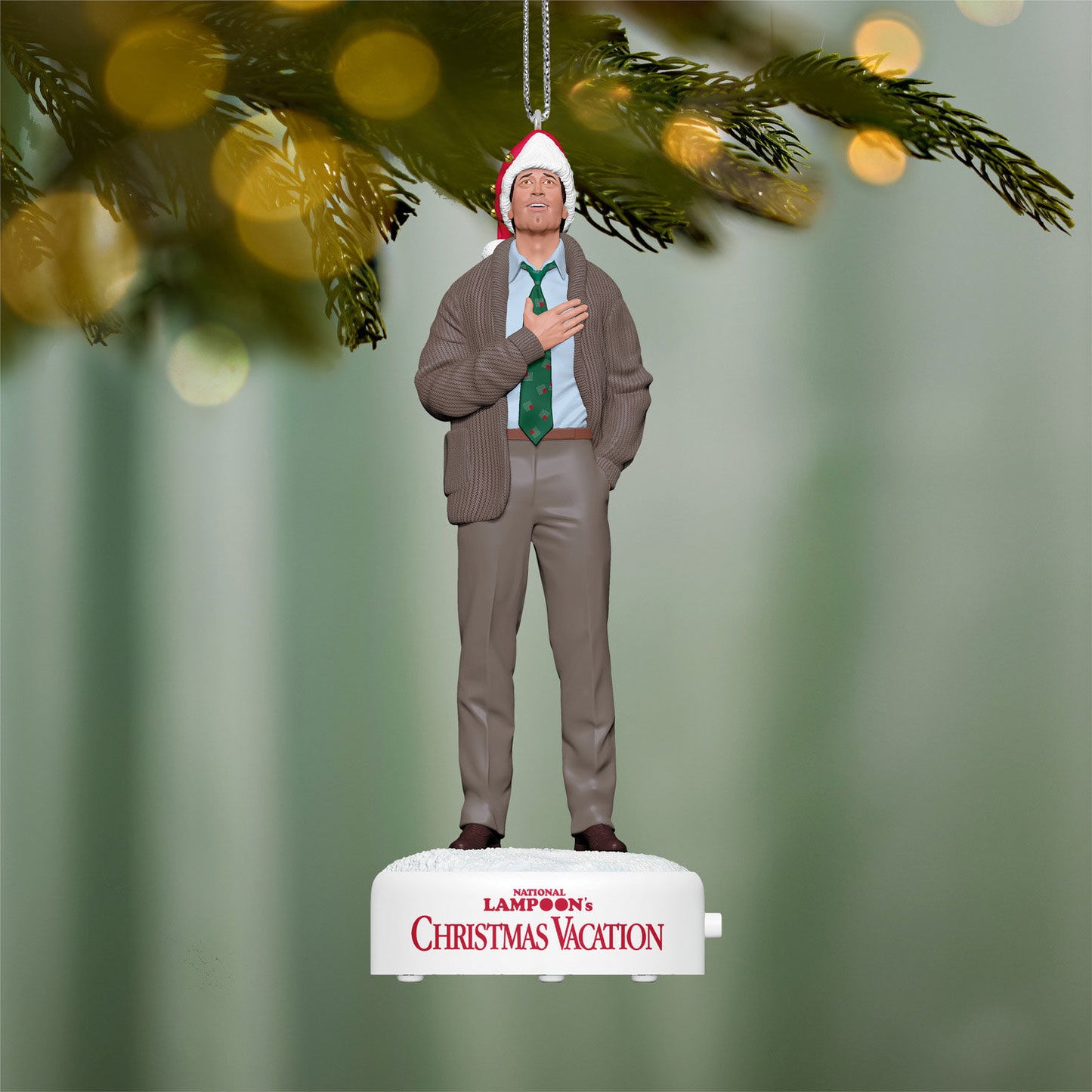 National Lampoon's Christmas Vacation™ Clark Griswold With Sound — 2026 Hallmark Keepsake Christmas Ornament, festive details of Clark in a Santa hat over a heartwarming Christmas background.