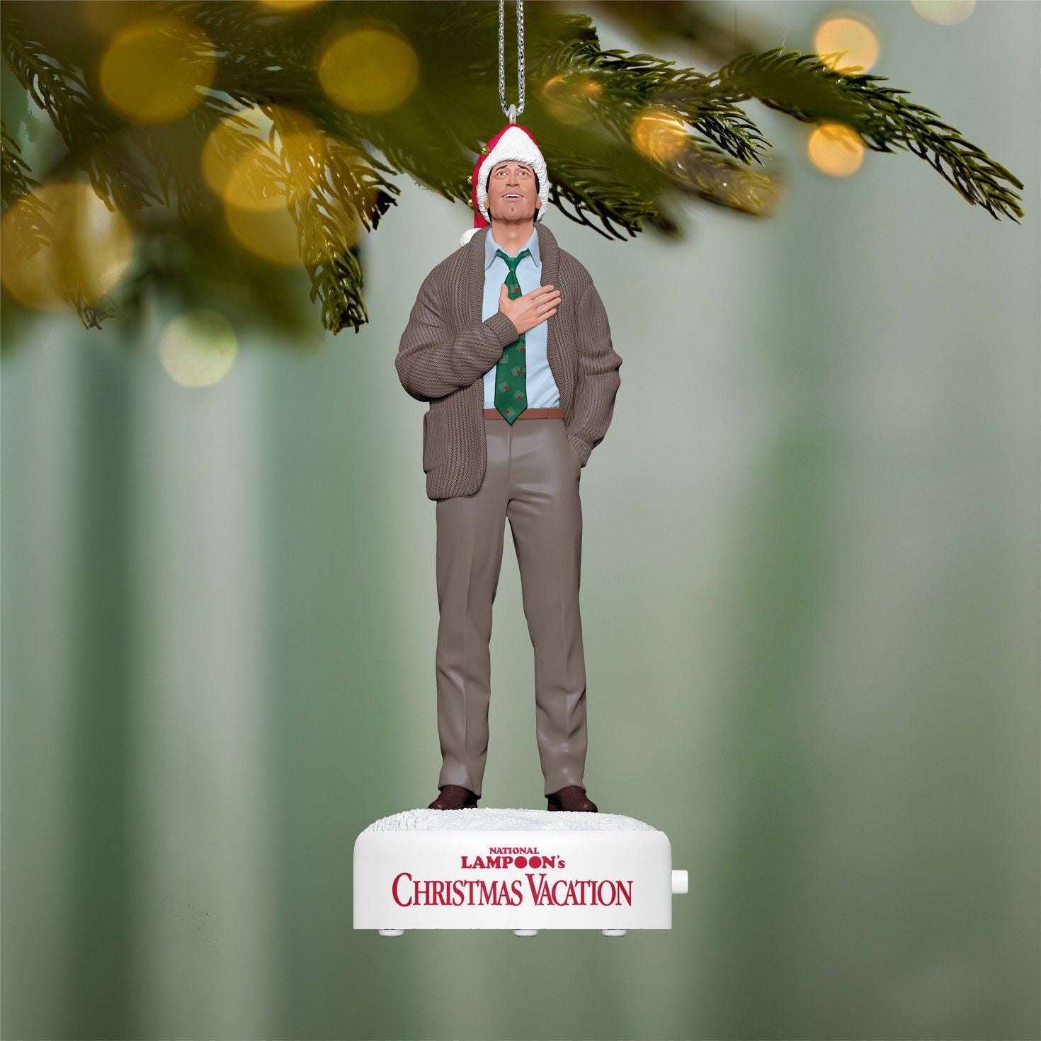 National Lampoon's Christmas Vacation™ Clark Griswold With Sound — 2026 Hallmark Keepsake Christmas Ornament, festive details of Clark in a Santa hat over a heartwarming Christmas background.