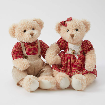Edward the Notting Hill Bear and Ethel in matching plaid outfits, featuring plush faux fur, sitting together on a white backdrop.
