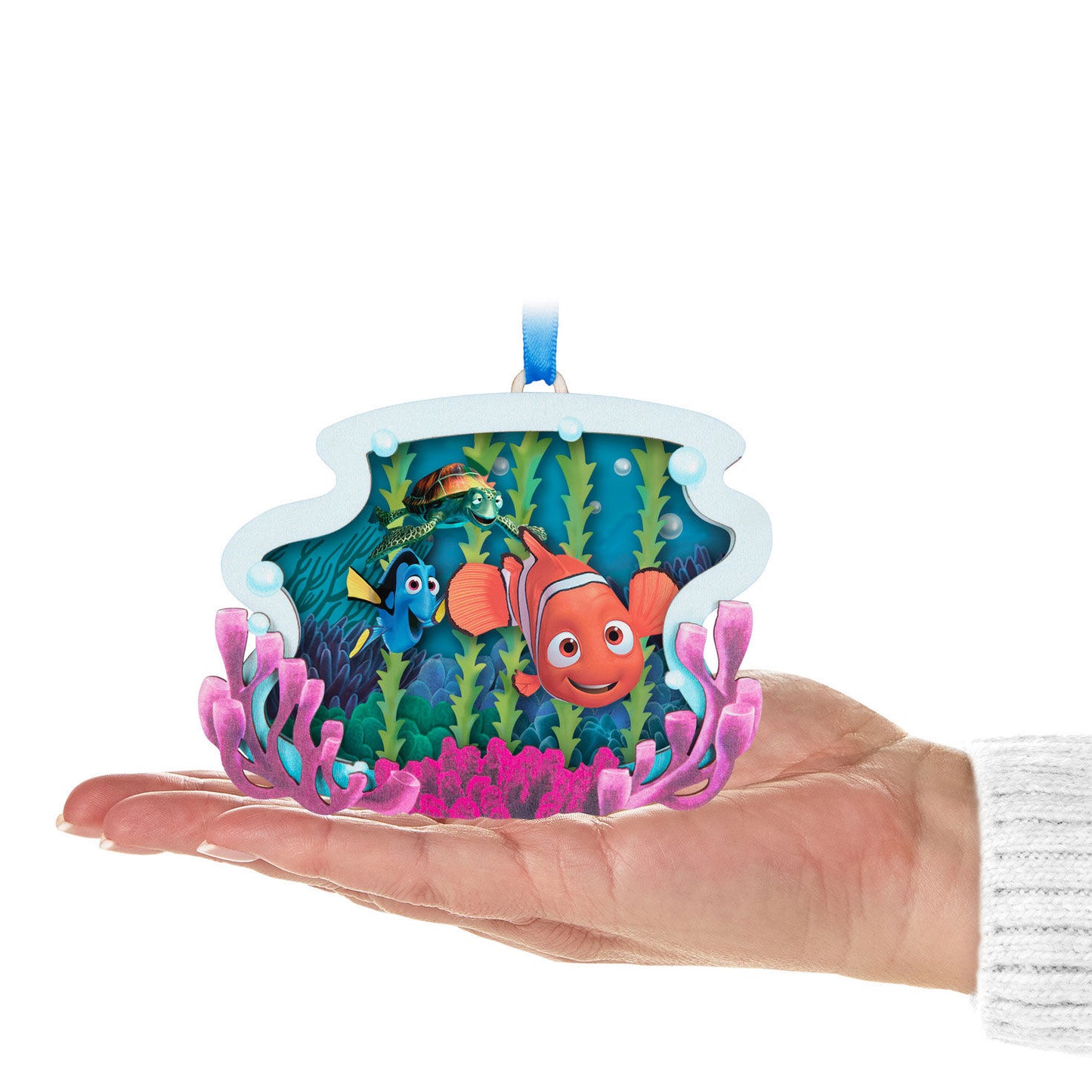 Disney and Pixar Finding Nemo, Totally Unforgettable Friends Papercraft ornament held in a hand, featuring vibrant characters and underwater scene.