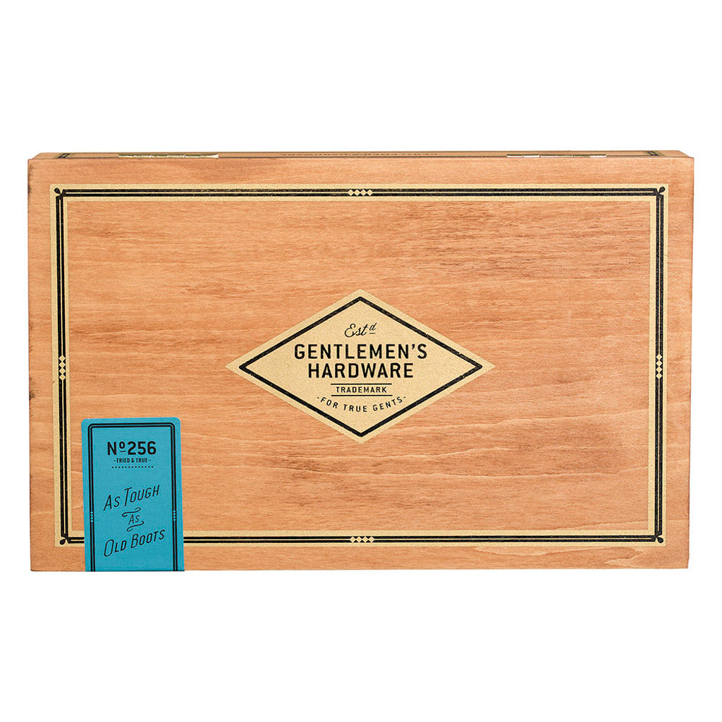 Shoe shine box made from natural wood, featuring engraved logo and vintage label design, angled view.