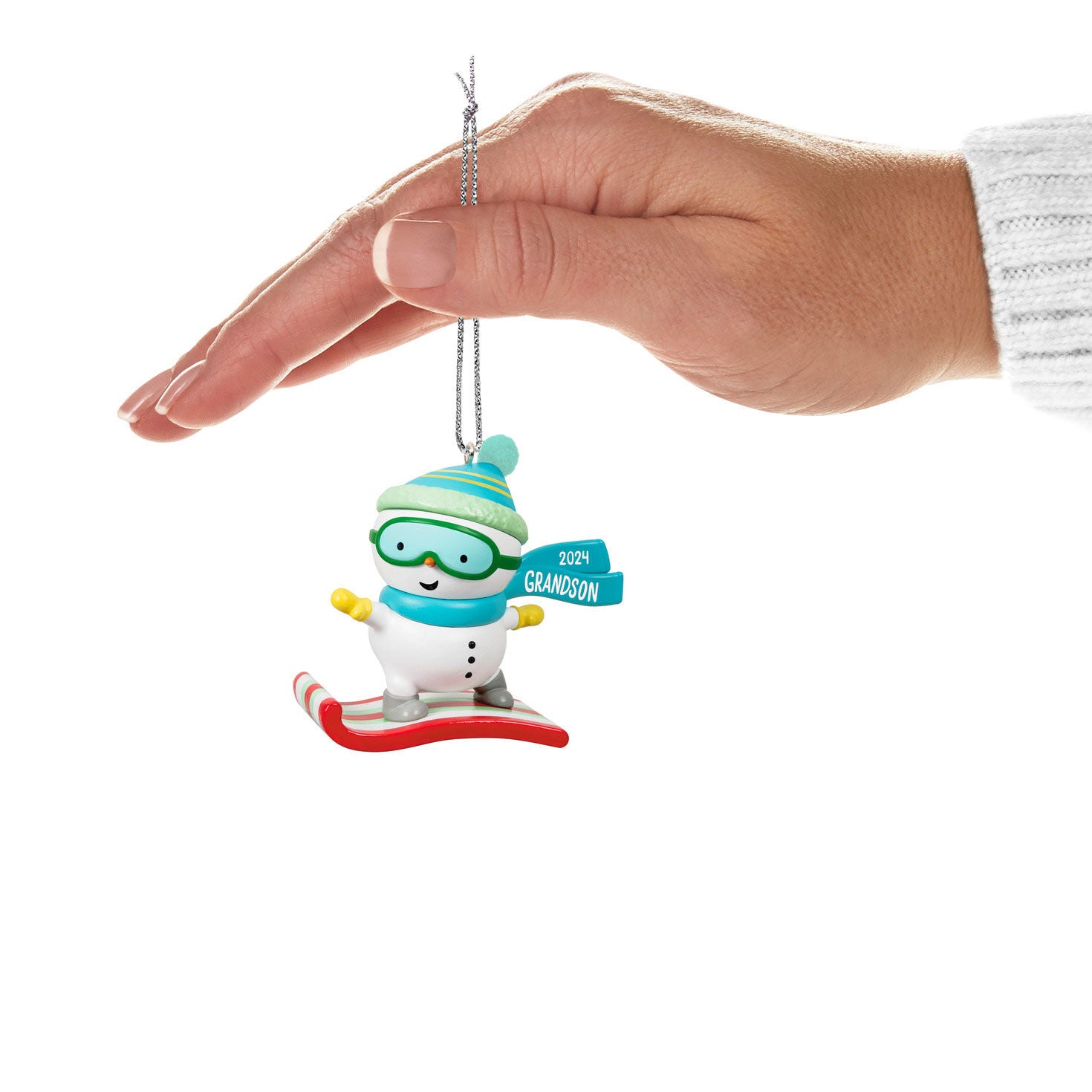 Grandson Snowboarding Snowman — Hallmark Keepsake Christmas Ornament in hand with teal hat and 2024 tag, festive decor.