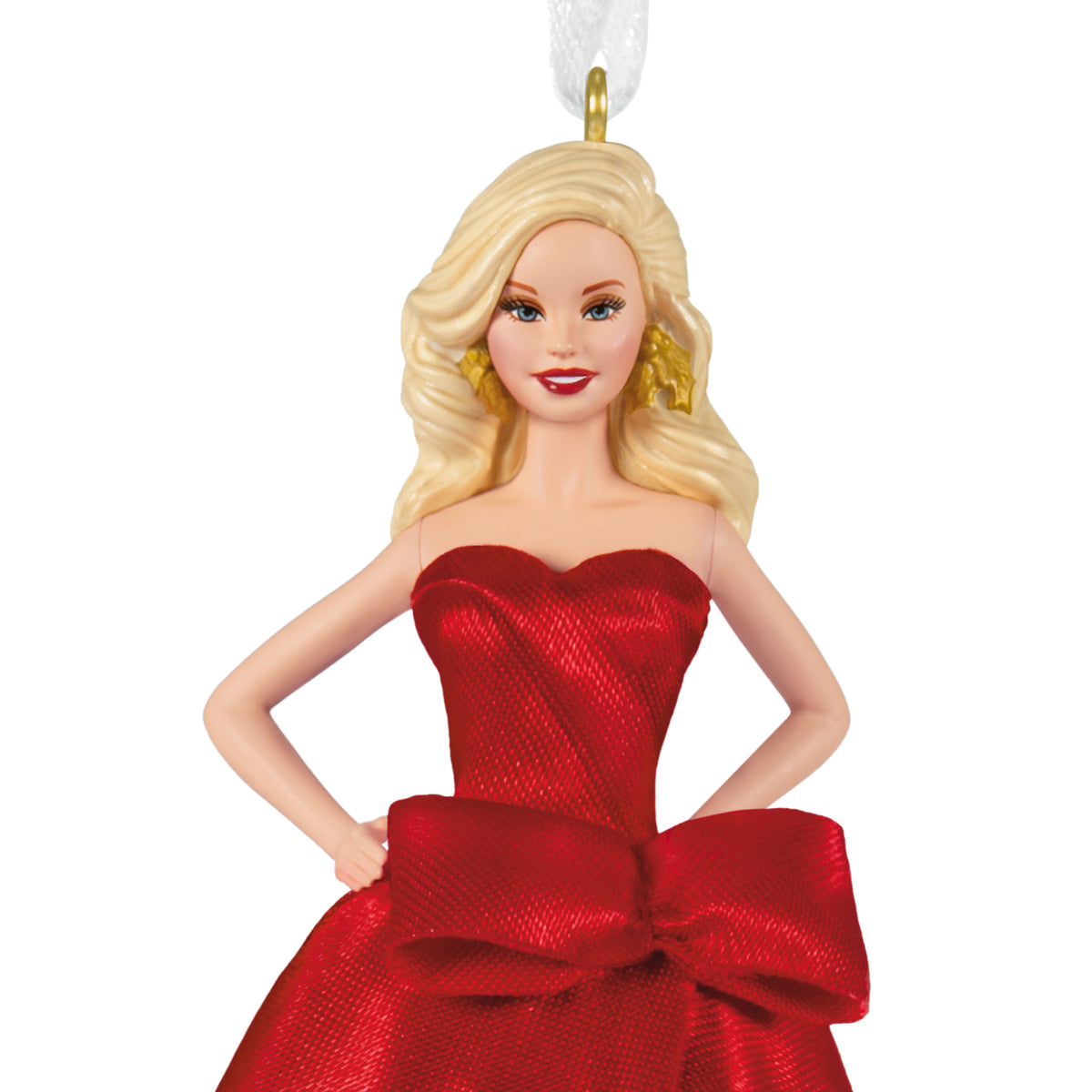 A blonde female ornament or doll wearing a strapless shimmering red dress with a large bow at the waist, posed against a plain white background.