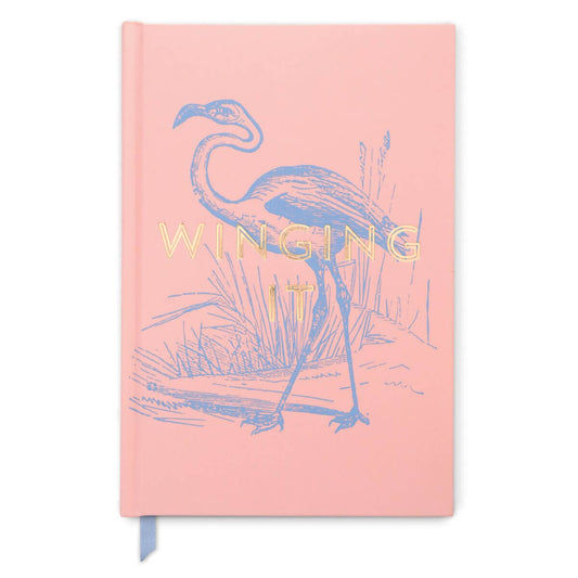 Flamingo "Winging It" Vintage Sass-Soft Touch Hardcover Book Bound, 5.75''X 8.5'' in soft pink with gold foil text and illustration.
