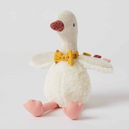 Gregory Goose Rattle, plush toy with a mustard bow tie, in a seated position, showcasing soft velour and faux fur details.