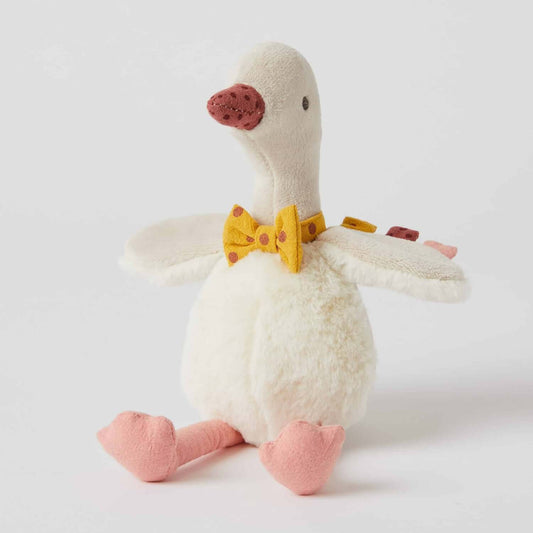 Gregory Goose Rattle, plush toy with a mustard bow tie, in a seated position, showcasing soft velour and faux fur details.