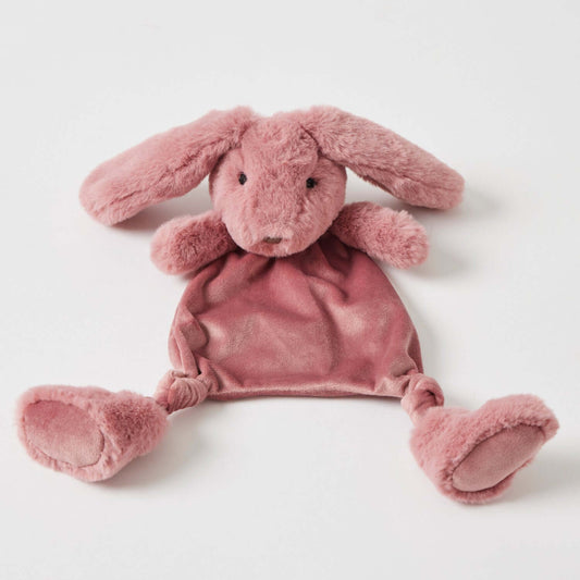 Raspberry Bunny Comforter in soft raspberry plush with floppy ears and comforting blanket base, laid flat on a white surface.