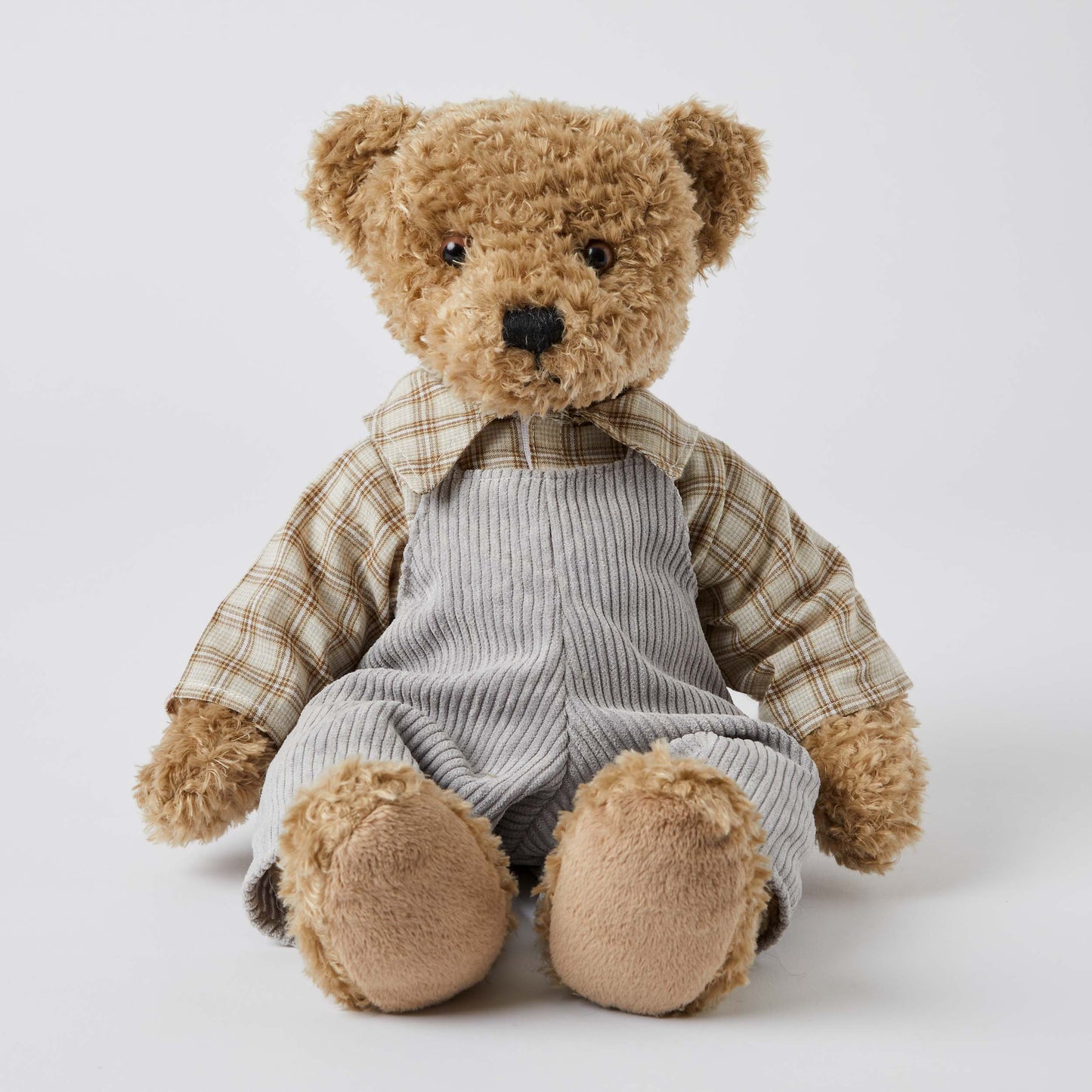 Chester the Notting Hill Bear in grey corduroy overalls and check shirt, seated view showcasing plush faux fur texture.