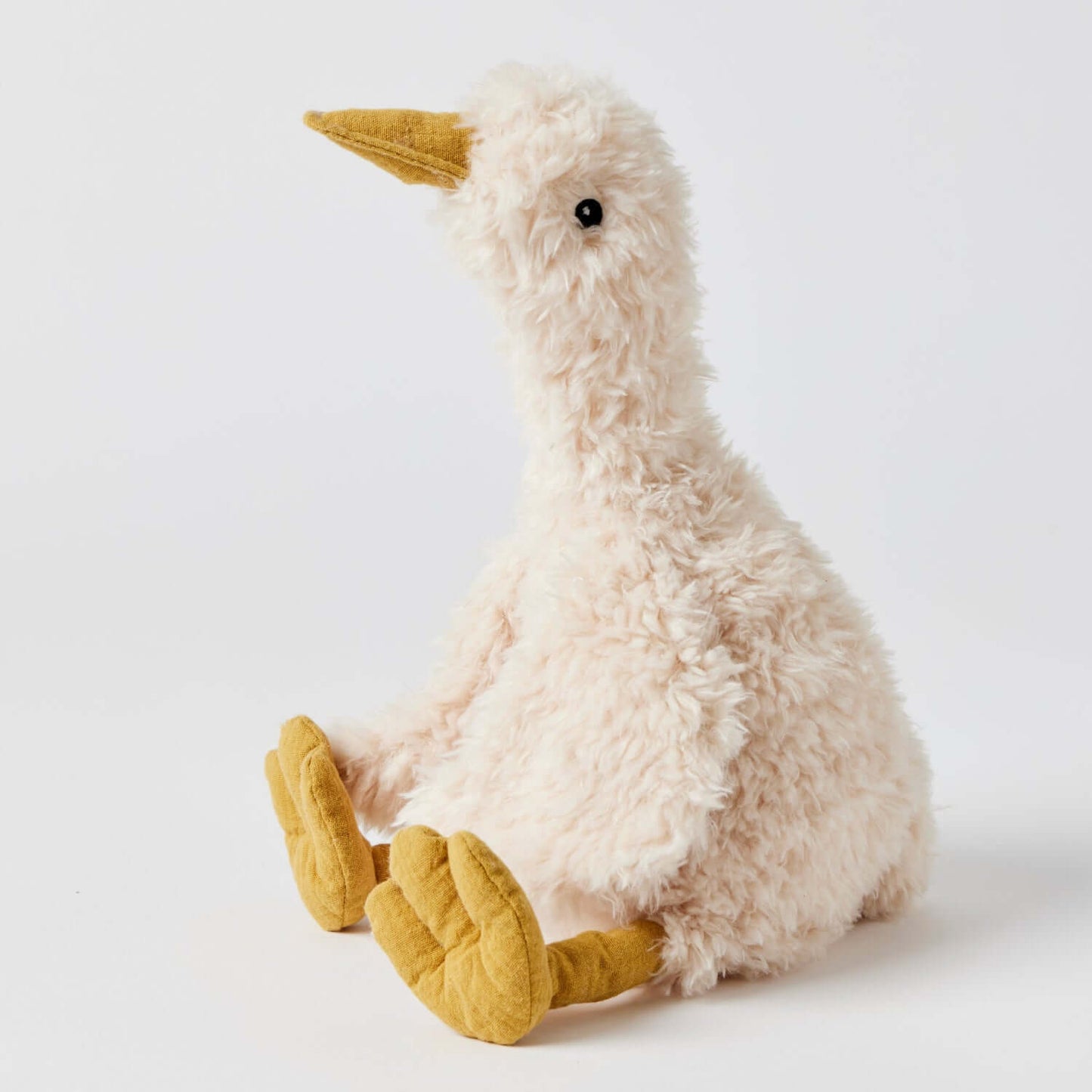 Wiggles the Duck plush toy, cream colour, soft fabric, side view, ideal for toddlers and newborns.