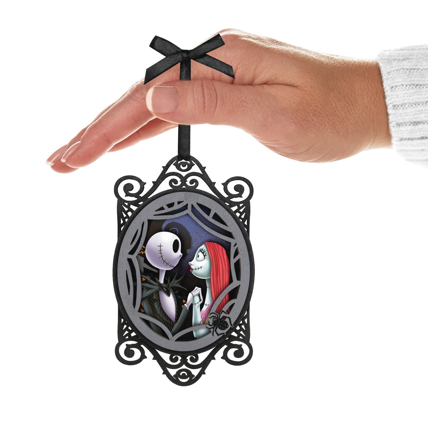 Disney Tim Burton's The Nightmare Before Christmas, Jack and Sally Papercraft — Hallmark Keepsake Christmas Ornament held in hand, featuring intricate black frame and vibrant character details.