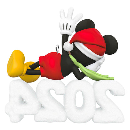 Disney Mickey Mouse, A Year of Disney Magic — Hallmark Keepsake Christmas Ornament featuring Mickey in a Santa hat and scarf, resting on a glittery 2024 snow sculpture.