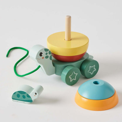 Pull along stacking turtle toy in multi-coloured wood, includes various stacking pieces and a pull cord.