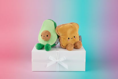 Avocado and Toast Magnetic Plush – Better Together set on a gift box, featuring vibrant colours and cute embroidered details.