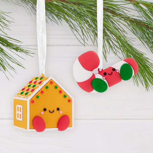 Better Together Gingerbread House and Candy Cane, shatterproof set of 2 with cute designs hanging on a pine branch close up