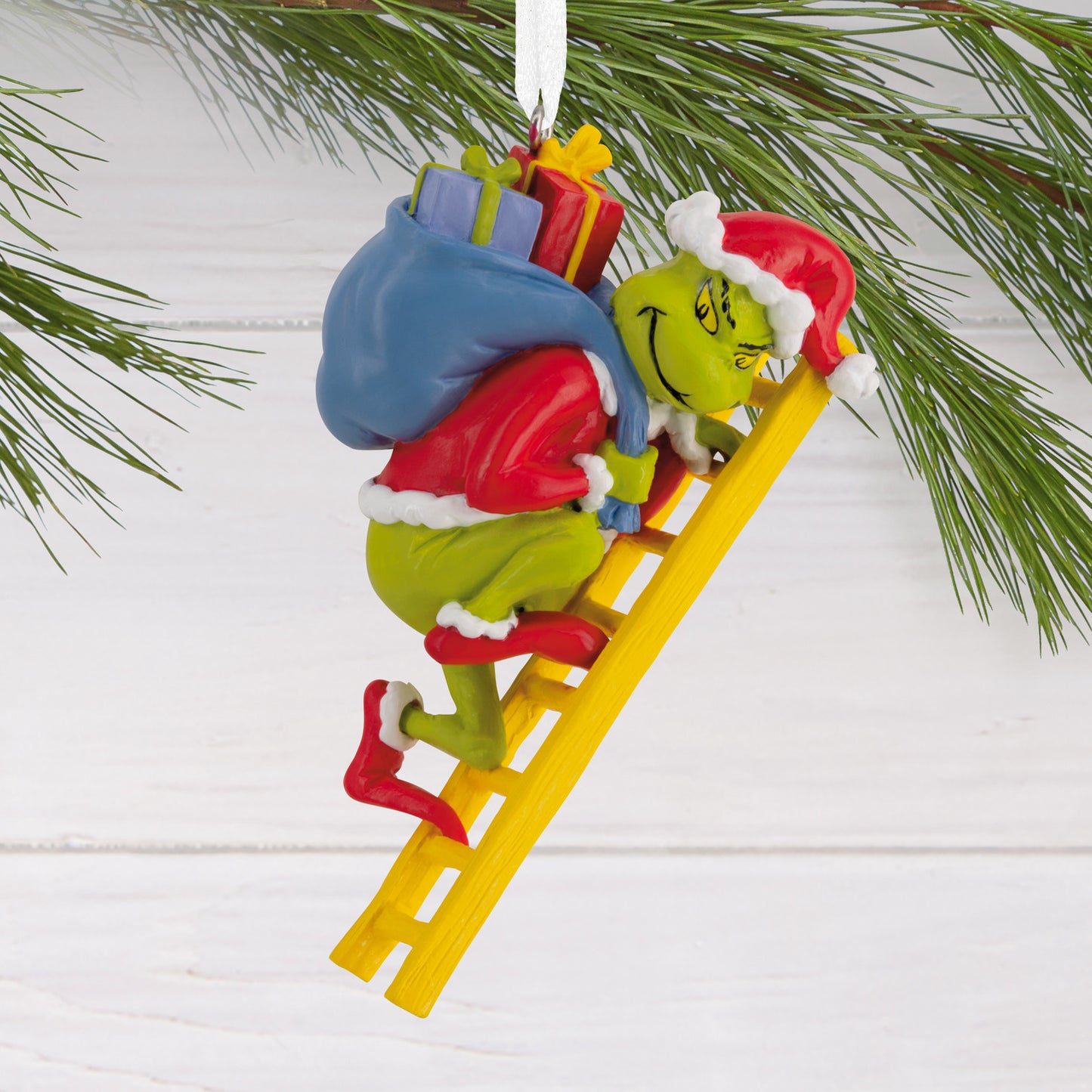 Hallmark Christmas Ornament - Dr. Seuss's How the Grinch Stole Christmas! features a colourful Grinch climbing a yellow ladder with a sack of gifts.